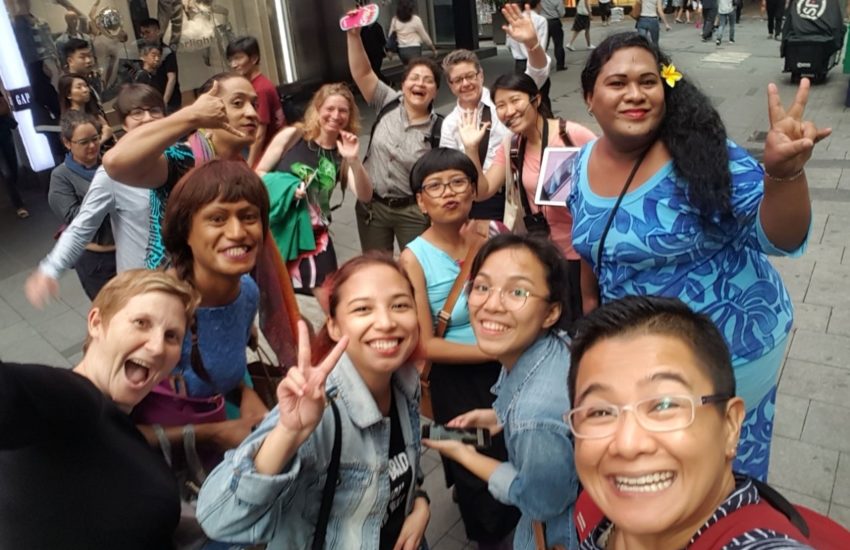 a group selfie shot with about 10 people pulling silly faces