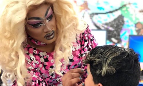 A drag queen applying make up to a kid.